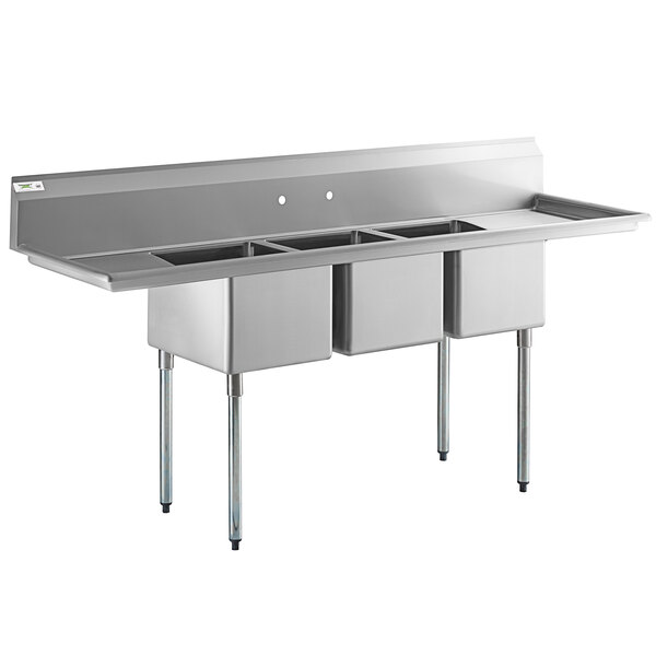 A large stainless steel three compartment commercial sink with two drainboards and galvanized steel legs.