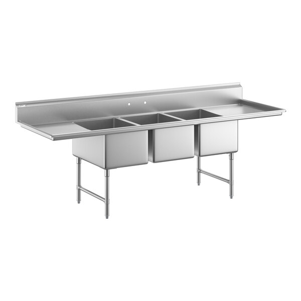 A large stainless steel sink unit with three deep compartments, two side drainboards, and sturdy metal legs with cross bracing.