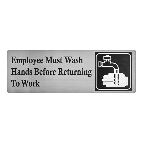 A stainless steel sign that reads 'Employee Must Wash Hands Before Returning To Work' with a handwashing symbol.