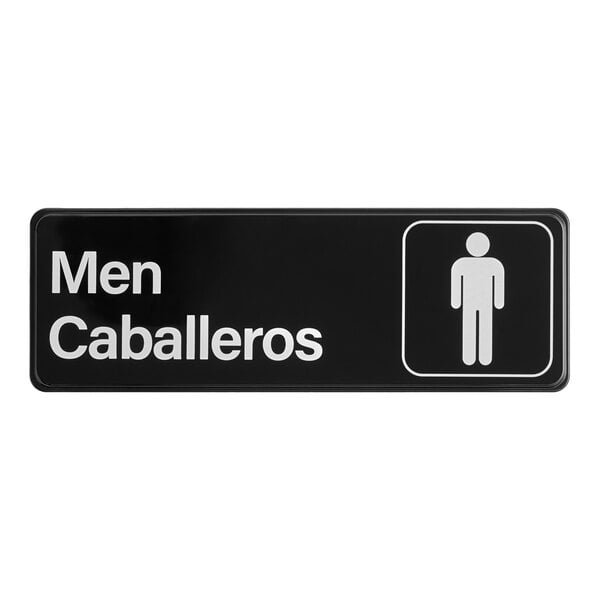 A rectangular black and white sign indicating a men's restroom with the words 'Men Caballeros' and a male figure icon.