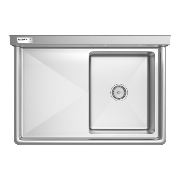 A stainless steel commercial sink with a single square basin on the right and a flat drainboard on the left.