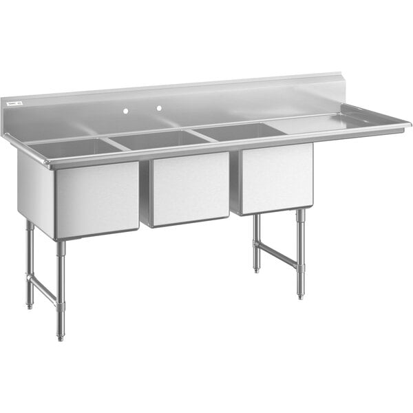 A large stainless steel three-compartment commercial sink with a right-side drainboard, stainless steel legs, and cross bracing.