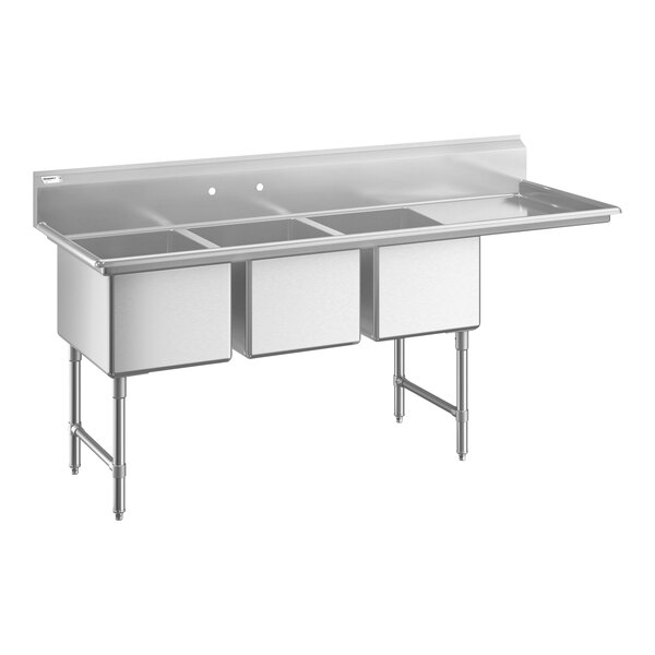 A large stainless steel commercial sink with three deep compartments, sturdy legs, cross bracing, a backsplash, and an extended drainboard on the right side.