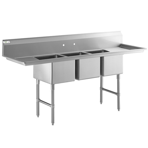 A large stainless steel three-compartment commercial sink with two drainboards, stainless steel legs, and cross bracing.