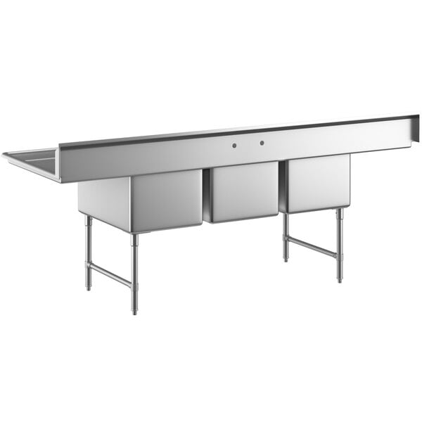 A large stainless steel three compartment commercial sink with two drainboards, stainless steel legs, and cross bracing.