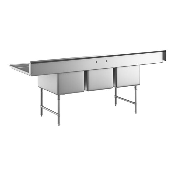 A large stainless steel sink with three deep compartments, two side drainboards, and sturdy metal legs with cross bracing.