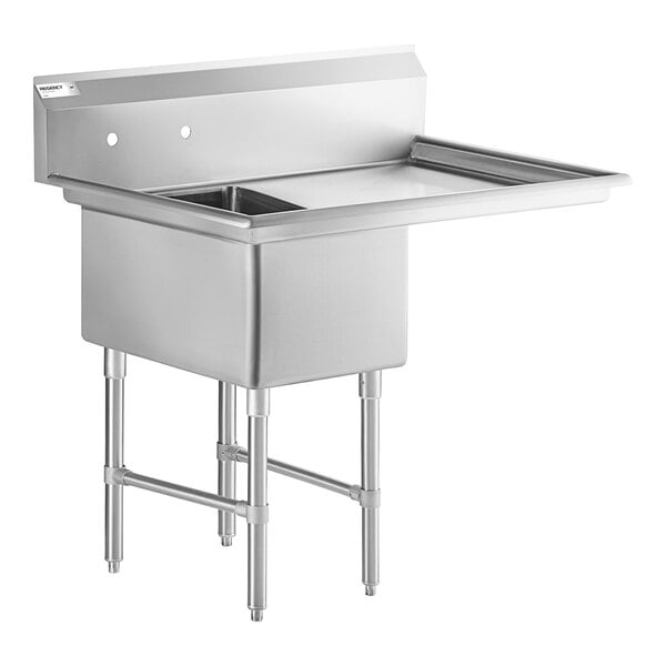 A stainless steel commercial sink with one deep basin, a right-side drainboard, and four sturdy legs with cross bracing.