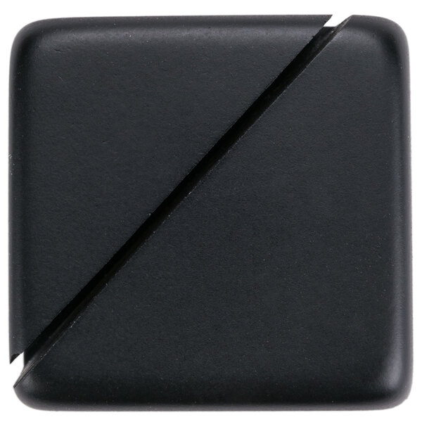 A black acrylic cube card holder with a diagonal slot for holding cards.