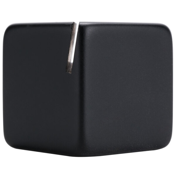 A black acrylic cube card holder with a metal slot for holding cards.