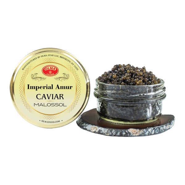 A glass jar of OLMA Imperial Amur Caviar with a gold lid labeled 'Imperial Amur Caviar Malossol,' containing 56 grams of caviar.