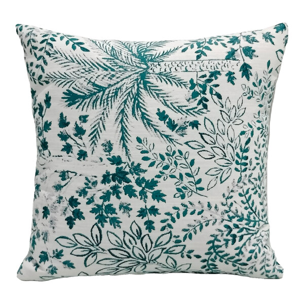 A square pillow with a tropical jade leaf pattern on a white background.
