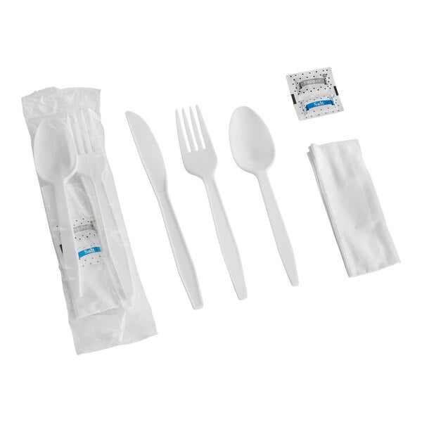 A white heavy weight plastic cutlery pack including a fork, knife, spoon, napkin, and salt and pepper packets.