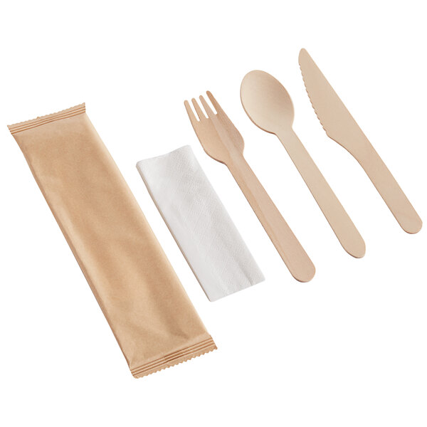 A compostable wooden cutlery set with a fork, spoon, knife, napkin, and a brown paper wrapper.