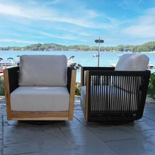 A modern outdoor swivel chair featuring black rope sides, teak wood accents, and light-colored Sunbrella cushions.