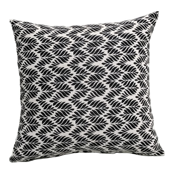 A square pillow with a black leaf pattern on a white background.