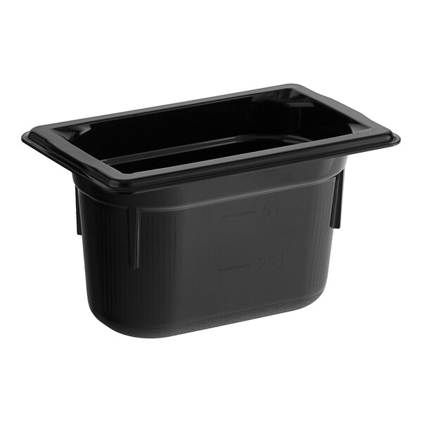 A black plastic Vollrath food pan on a table.