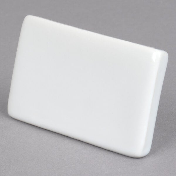 A rectangular white ceramic card sign.