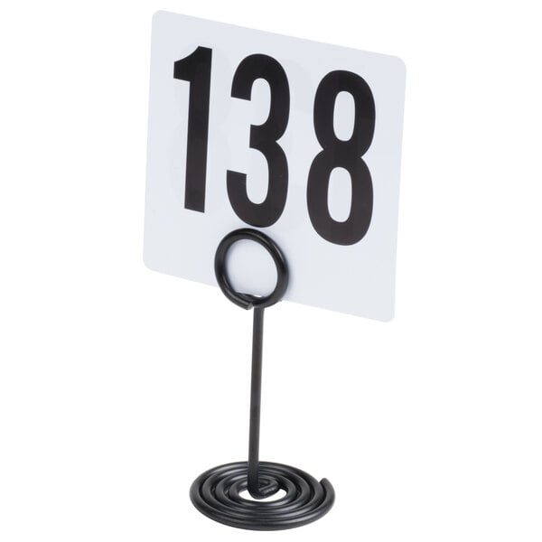 A black metal swirl base card holder displaying a card with the number 138.