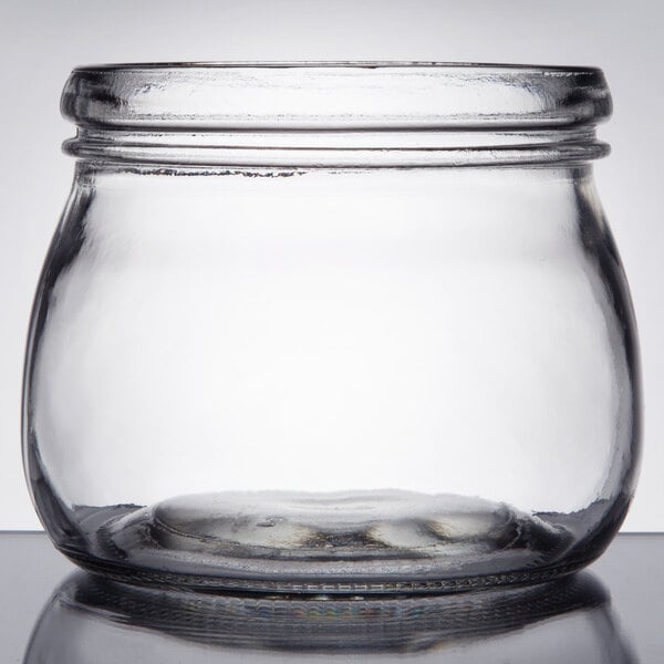 A clear glass mason jar with a wide mouth and a 16 oz. capacity.