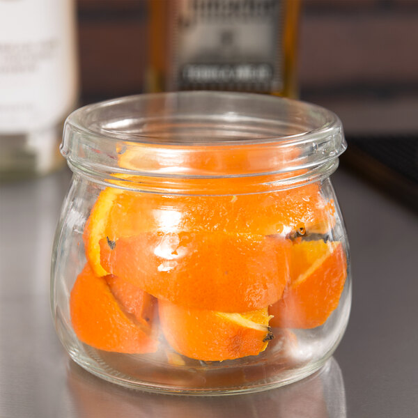 A clear glass mason jar filled with orange slices, designed for use as a 16 oz. condiment container.