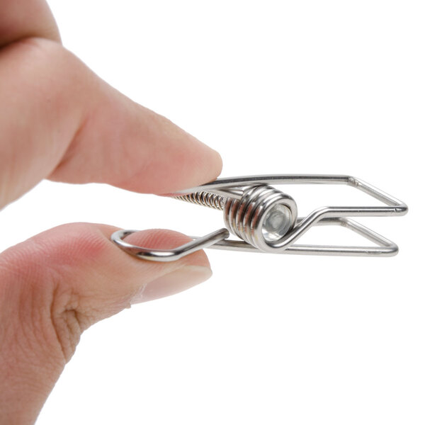 A metal double-sided flexible sign clip being held between two fingers.