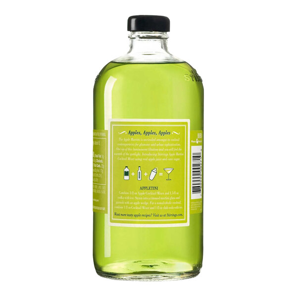 A clear glass bottle filled with green Stirrings Apple Cocktail Mix and sealed with a black cap.