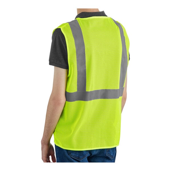 A lime high visibility safety vest with reflective stripes, shown from the back, worn over a dark shirt.