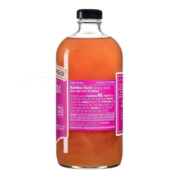 A glass bottle of Stirrings Mai Tai Mix with an orange liquid and a pink label.