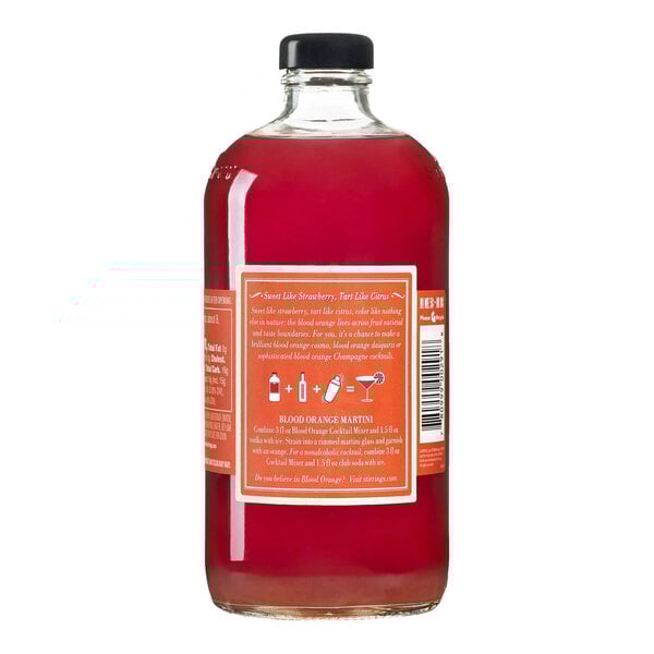 A clear glass bottle filled with red Stirrings Blood Orange Cocktail Mix and sealed with a black cap.