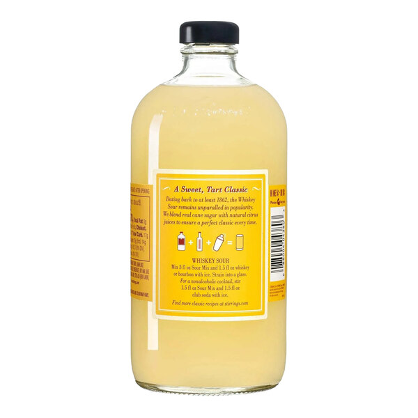 A clear glass bottle filled with yellow Stirrings Sour Mix and sealed with a black cap.