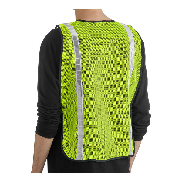 A lime high visibility safety vest with reflective tape, shown worn over a black shirt.