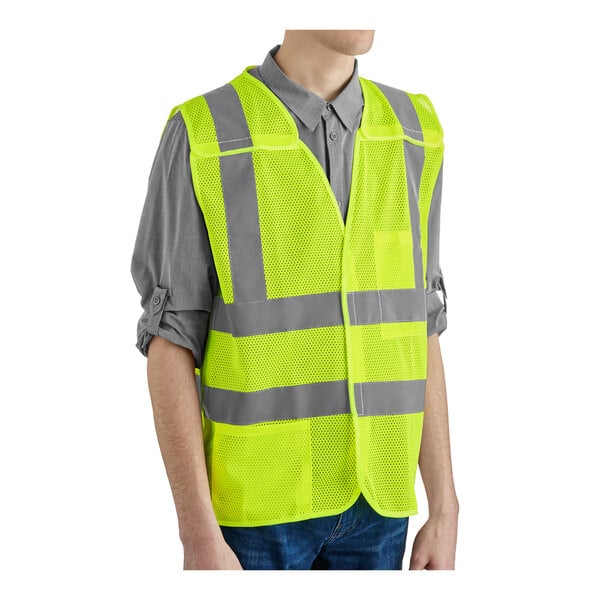 A lime high visibility safety vest with reflective stripes and a hook and loop closure.