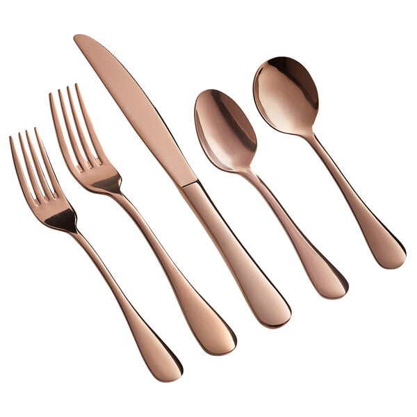 A five-piece set of rose gold stainless steel flatware including two forks, a knife, and two spoons.