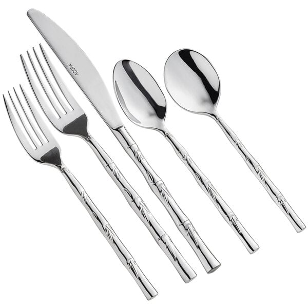 A five-piece set of stainless steel flatware with a decorative handle design.