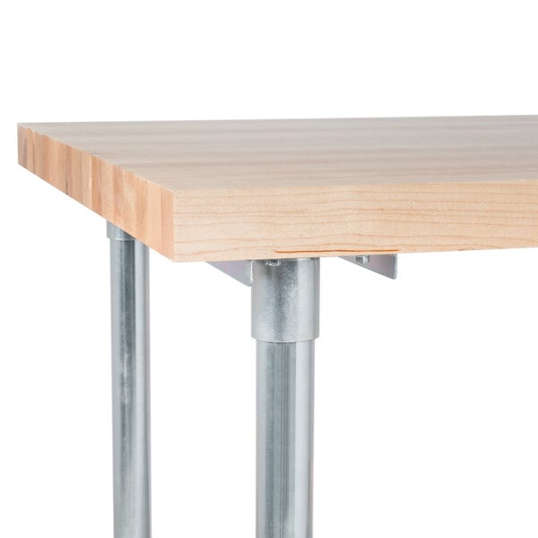 A wood table with metal legs and a metal undershelf.