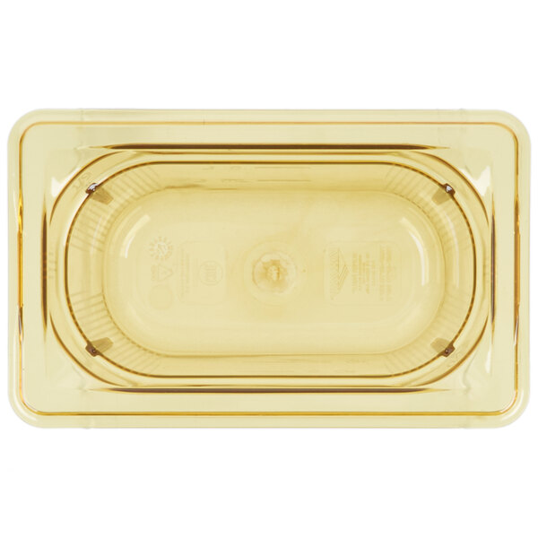 A clear plastic Vollrath 1/9 size food pan with amber color.