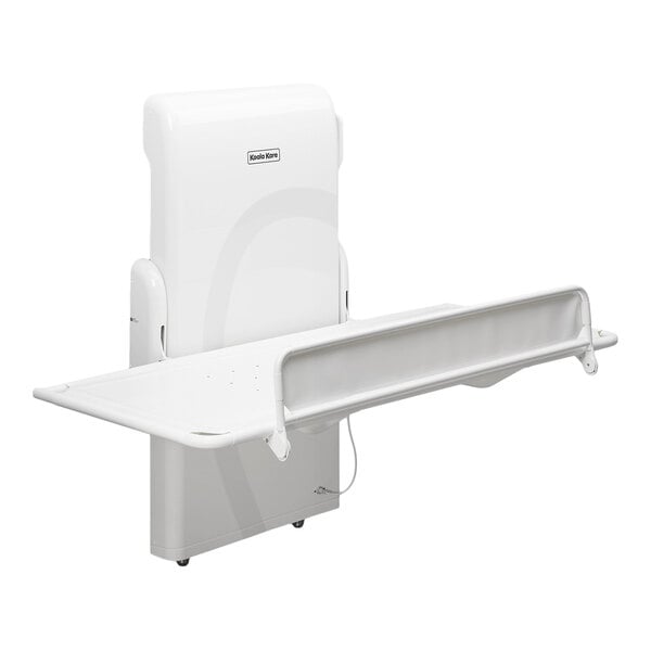 A white, wall-mounted horizontal changing station with an adjustable height platform and a safety rail.