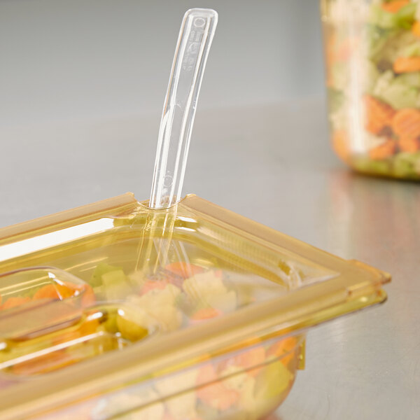 A Vollrath amber high heat slotted plastic lid on a plastic food pan.