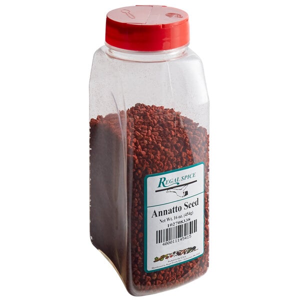 A plastic container of Regal annatto seed with a red lid and a 16 oz. label.