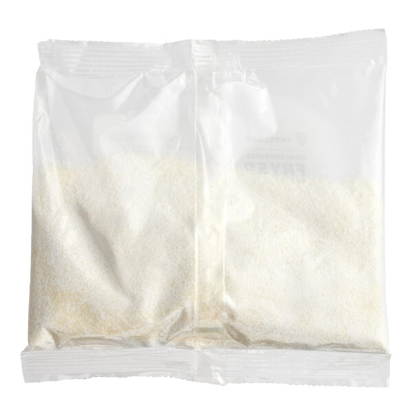 A clear plastic packet containing a white powdered concentrated fryer cleaner.