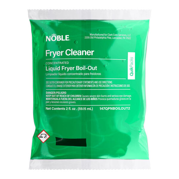A green packet of Noble QuikPacks 2 oz. Liquid Boil-Out Fryer Cleaner.