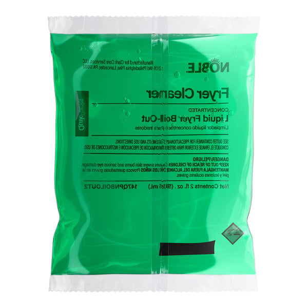 A green packet of Noble QuikPacks 2 oz. Liquid Boil-Out Fryer Cleaner.