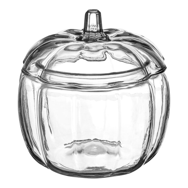 A clear glass jar with a lid shaped like a pumpkin.