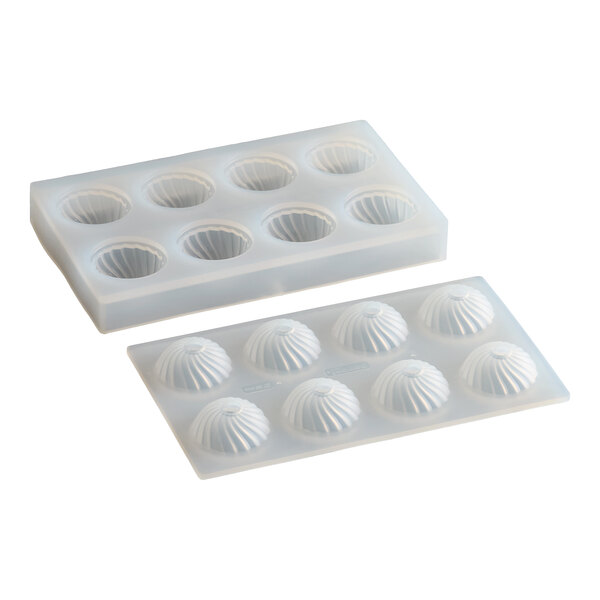 A silicone chocolate mold with eight sphere-shaped compartments, each featuring a fluted design.