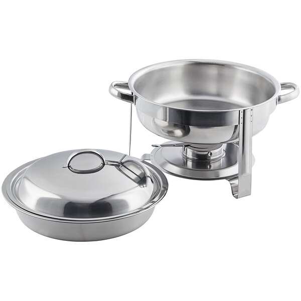 A round stainless steel chafer with chrome accents, featuring a lid and handles, used for keeping food warm at buffets or events.