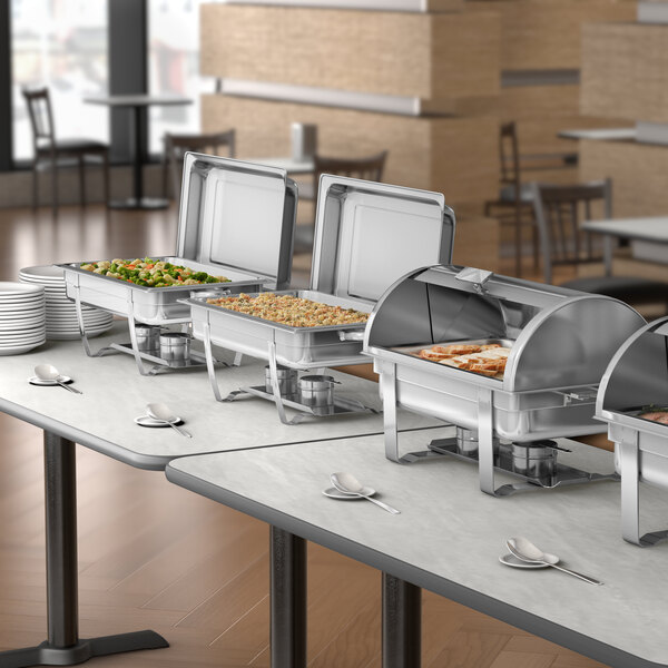 A stainless steel roll top chafer with chrome accents used for serving hot food at buffets or events.