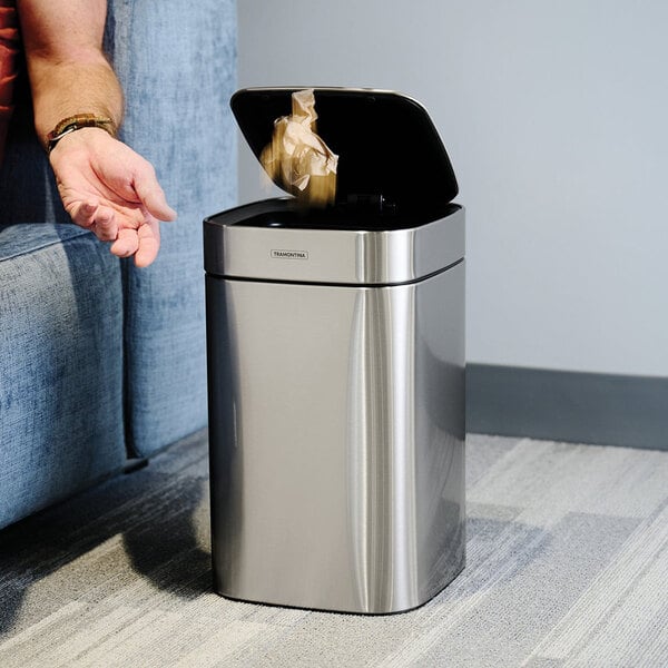 A 3-gallon stainless steel square wastebasket with an automatic lid.