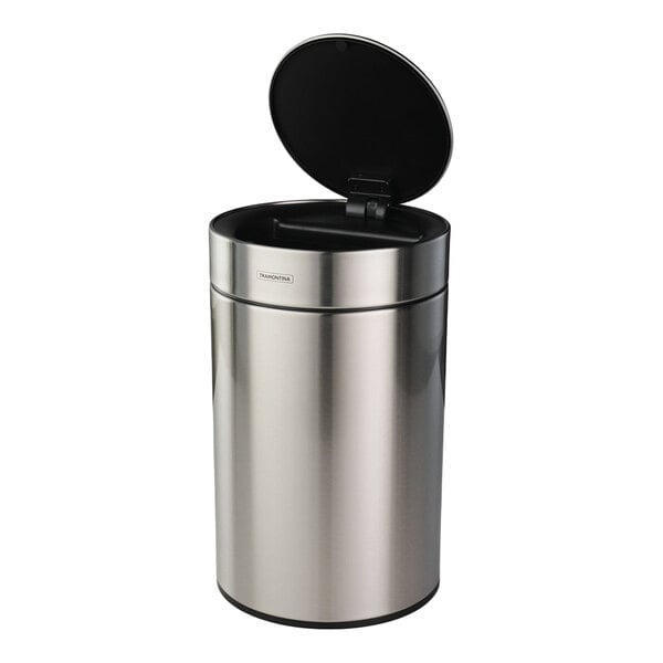 A stainless steel round wastebasket with an automatic lid.