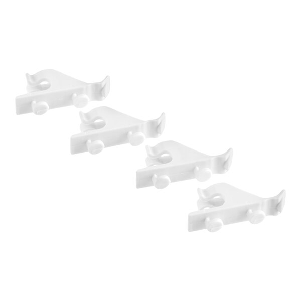 Four white plastic clips with two round pegs each, arranged in a diagonal line on a white background.