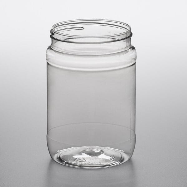A clear 32 oz. round PET plastic jar.